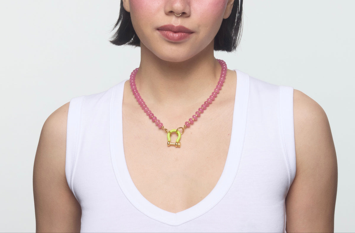 Front view of Wanda Necklace showcasing hot pink quartz, lime green spacer beads, and enamel carabiner on a model