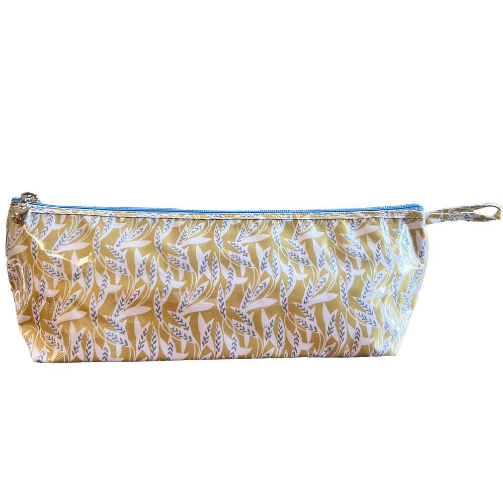 Front view of long Brush Bag in Leaf Dance print with vinyl-covered exterior, blue top zipper, and side loop on white background