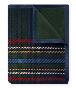 Folded wool blanket with navy blue border displaying green, red, and gold tartan plaid pattern with diagonal stripes.