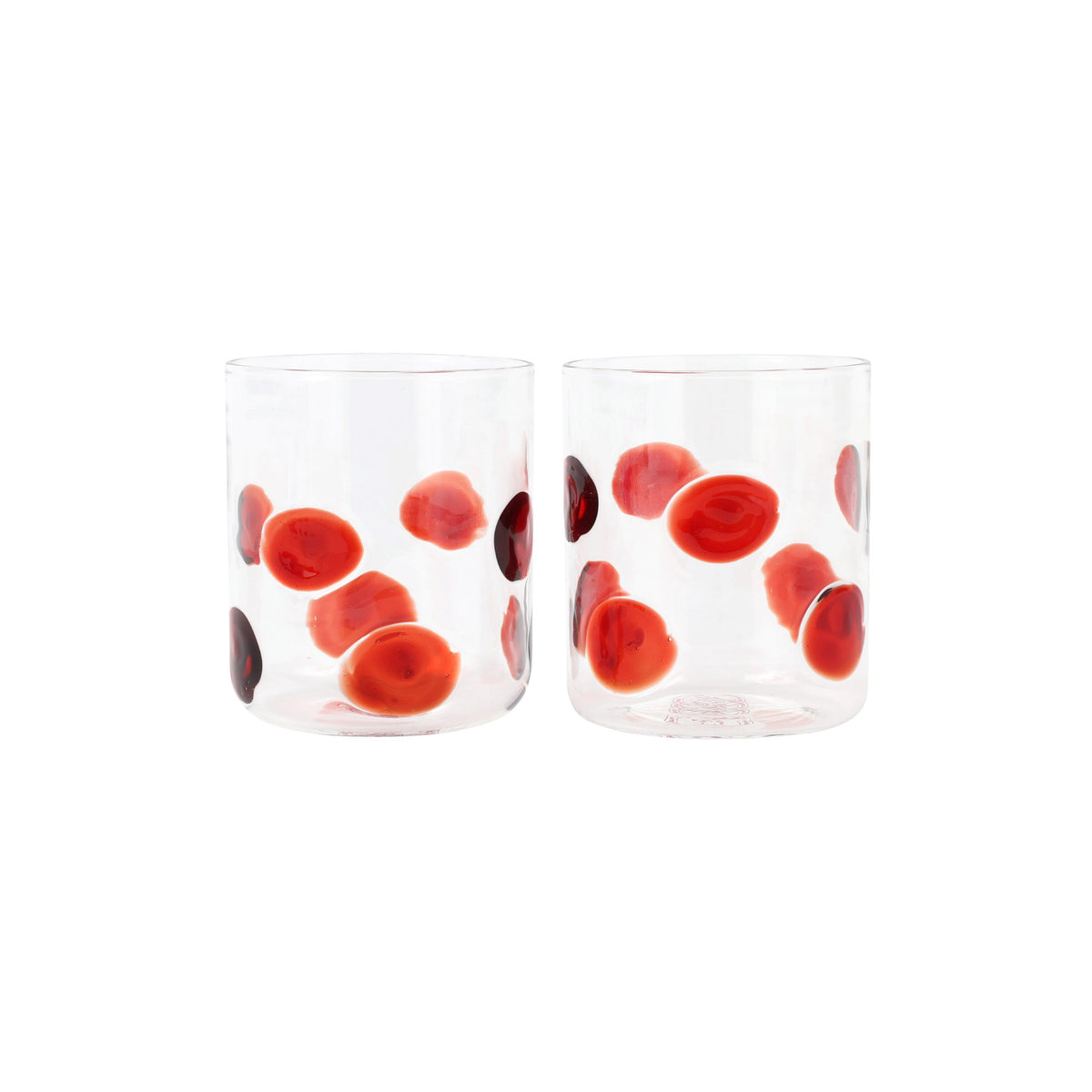 Front view of Drop double old fashioned glasses, set of 2, showcasing red dot pattern on clear glass against white background