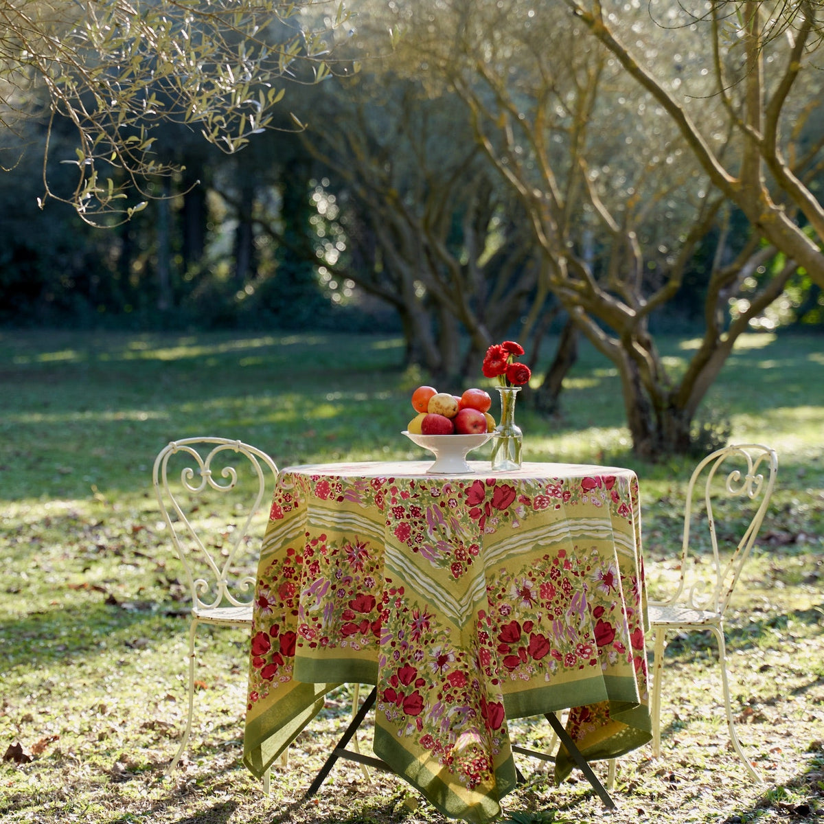 Front view of French Tablecloth Jardin Red and Green showcasing its floral garden pattern on an outdoor table