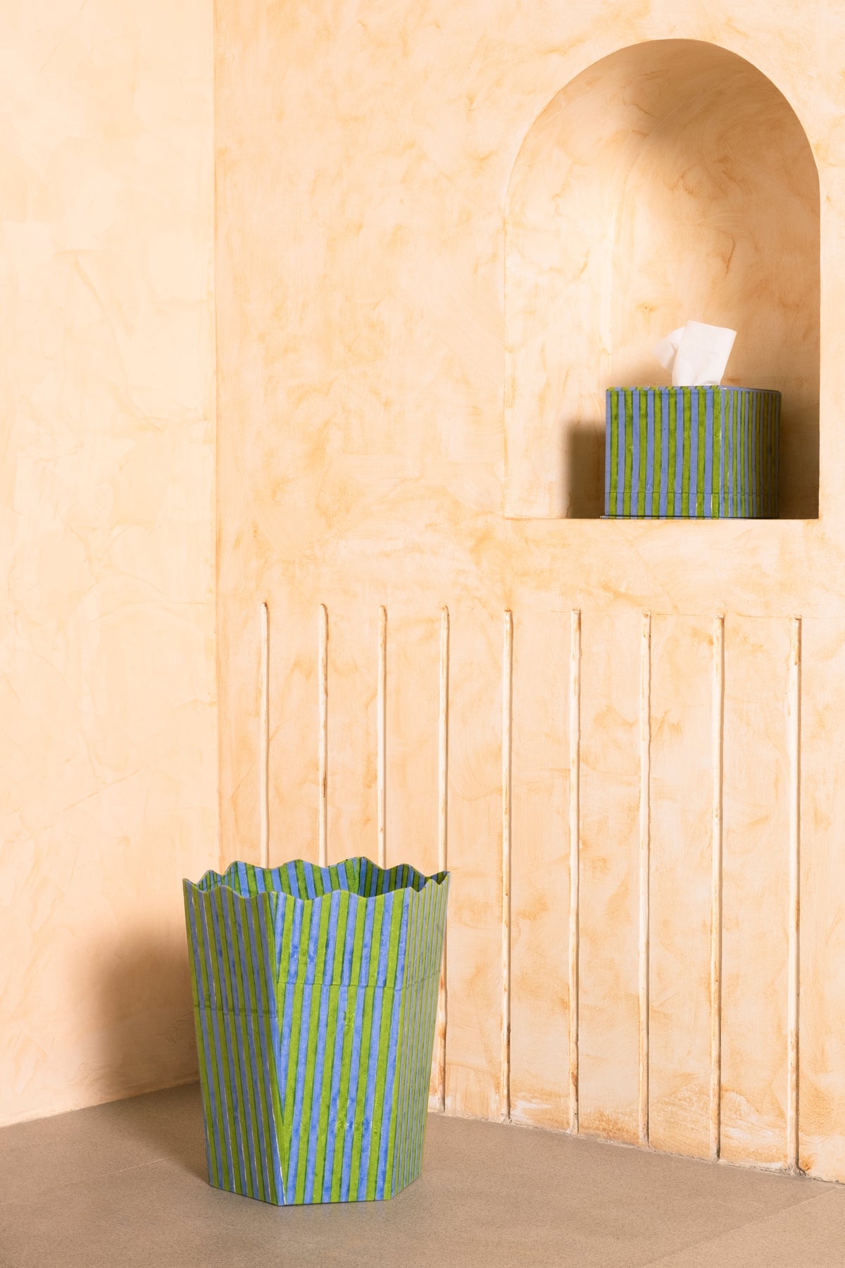 Green and blue striped blockprint tissue box set displayed against warm-toned wall