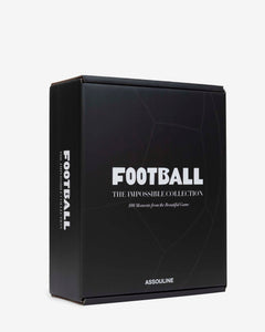 Football: The Impossible Collection by Assouline: three-quarter view of the closed matte black outer presentation box; the face reads FOOTBALL in bold white type, THE IMPOSSIBLE COLLECTION below, and 100 Moments from the Beautiful Game in italic; ASSOULINE in small white at the base; a subtle soccer ball pattern is embossed on the black surface; spine reads FOOTBALL THE IMPOSSIBLE COLLECTION vertically; white background
