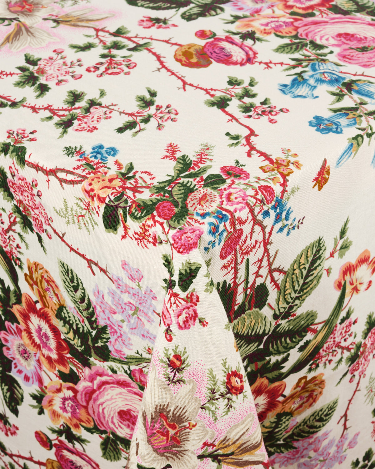 Close-up of D’Ascoli Adoria Tablecloth showcasing vibrant floral motif and folded linen texture