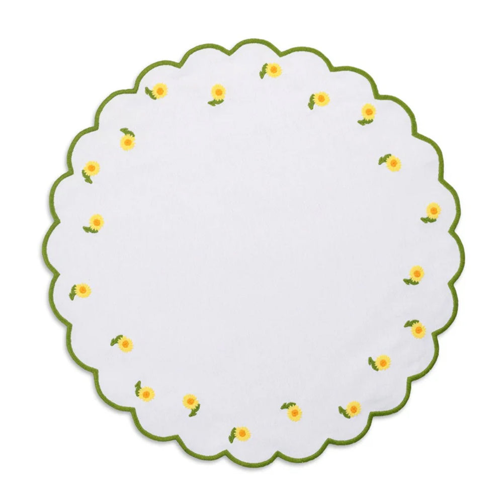 Top-down view of round Daisy placemat showcasing scalloped edge and embroidered yellow daisies with green trim on white background