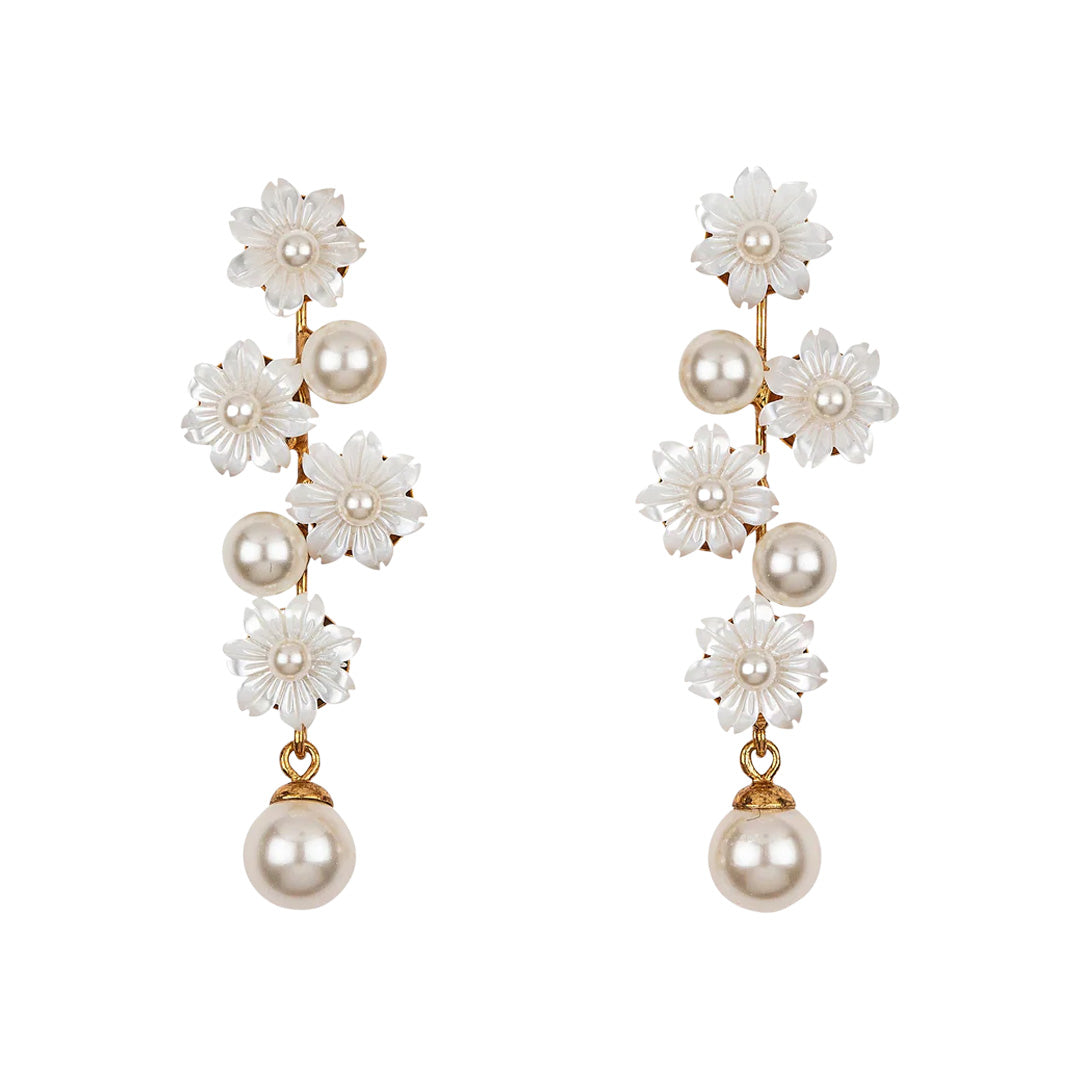Front view of Calissa earrings with carved mother-of-pearl flowers and pearl drops on gold posts against white background