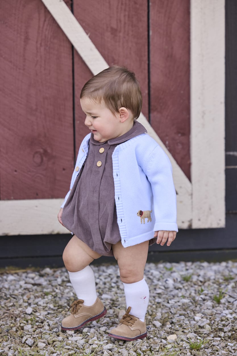 Little English traditional children's clothing company.  Short sleeve peter pan bubble in chocolate brown corduroy with wood button details for baby boys.  Paired with light blue cardigan with crochet abs on each side.