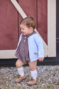 Little English traditional children's clothing company.  Short sleeve peter pan bubble in chocolate brown corduroy with wood button details for baby boys.  Paired with light blue cardigan with crochet abs on each side.