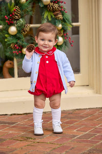 Little English classic children's clothing.  Red corduroy bubble with white contrast piping for baby boys for the holidays. Paired with light blue cardigan with holiday train embroidery