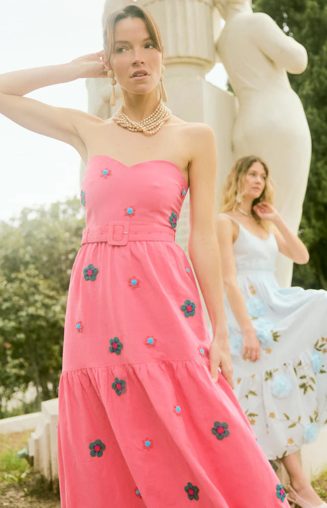 Front view of Days Gown in Pink Party showcasing strapless sweetheart neckline and beaded floral details with an outdoor garden background