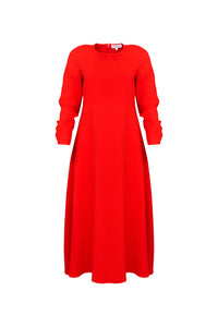 The Delancey Dress is long-sleeve with a shirred round neckline, banded cuffs, and a full skirt.