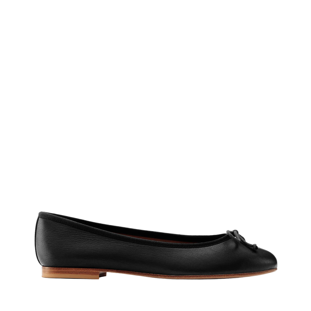 The Demi - Black Nappa by margaux-development is a handmade black leather ballet flat from Spain, with a small toe bow and low brown sole, shown in side view against a plain light background.
