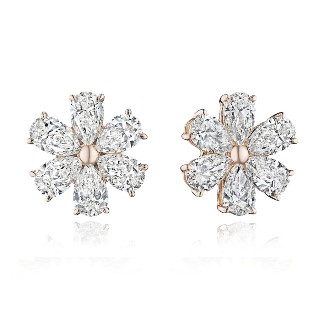 Floral Studs with Pear Shape Diamonds in Rose Gold: These flower-shaped earrings feature multiple SI clarity pear-shaped diamonds as petals around a central rose gold setting, shown against a white background.