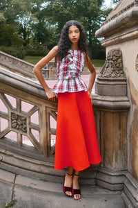 The Doering Top is a fitted V-neck silhouette with ruffles, shirring, and a peplum waist. 