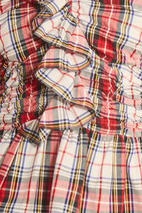 The Doering Top is a fitted V-neck silhouette with ruffles, shirring, and a peplum waist. 