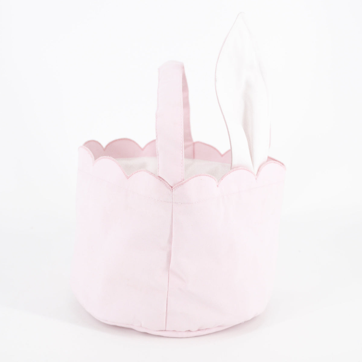 Close-up of the pink Easter Basket showcasing propped bunny ears and scalloped trim on a white background