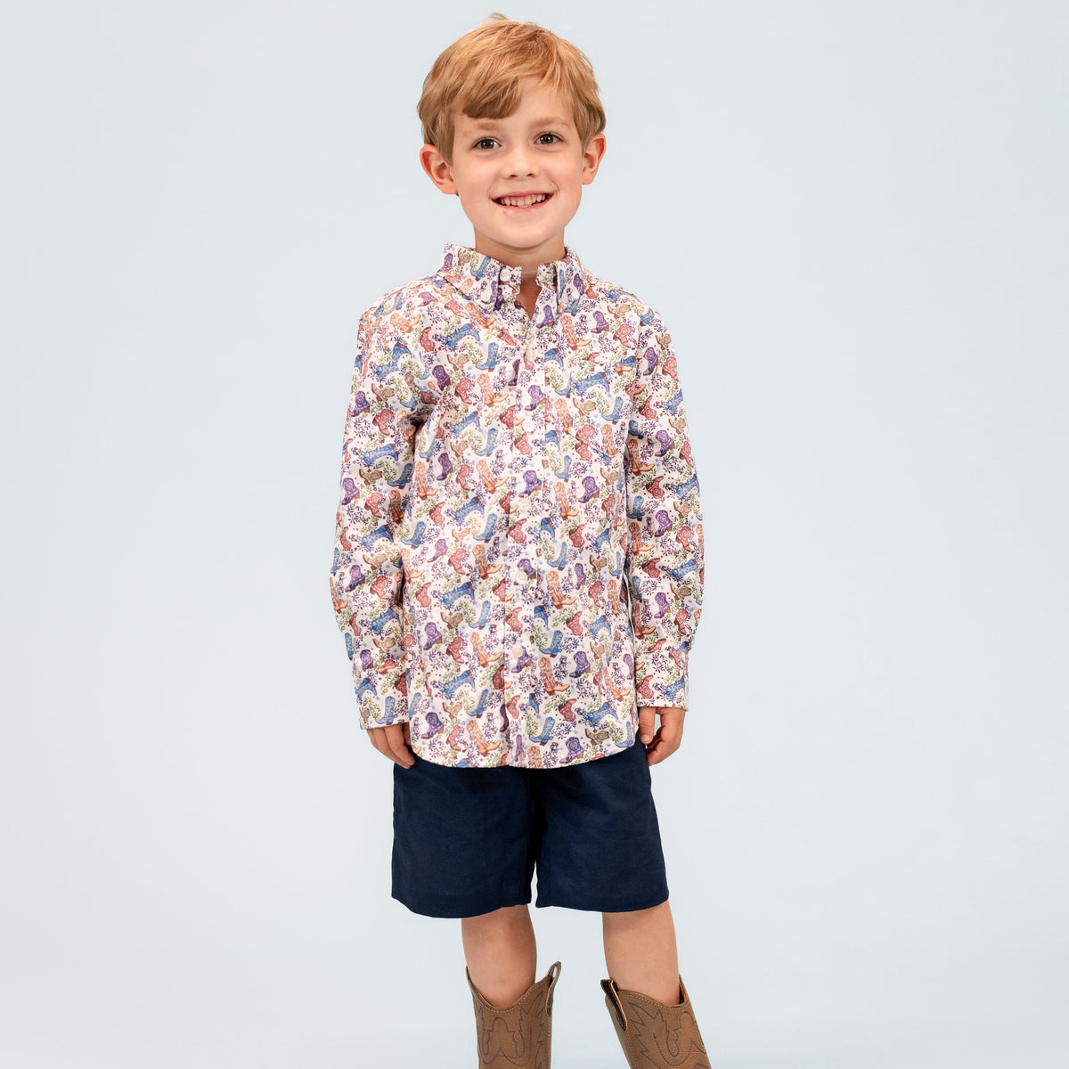 Front view of Bates Boy button-down showing multicolored paisley print on a boy model against light gray background