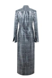 Back view of Doris Pailette in Silver showcasing silver sequins, black plaid lines, and longline silhouette on white background