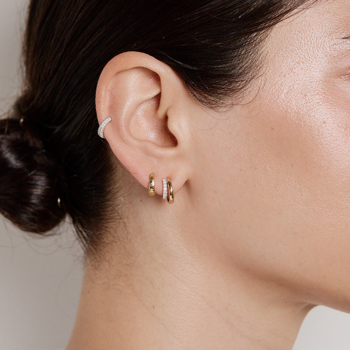 Side view of Doubled Diamond Tribute Hoops on model showing 18K yellow and white gold hoops with pavé diamonds