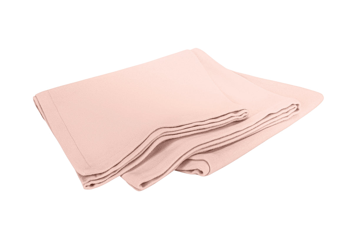 Angled view of Dream Modal Throw in blush showing folded layers and soft drape on white background