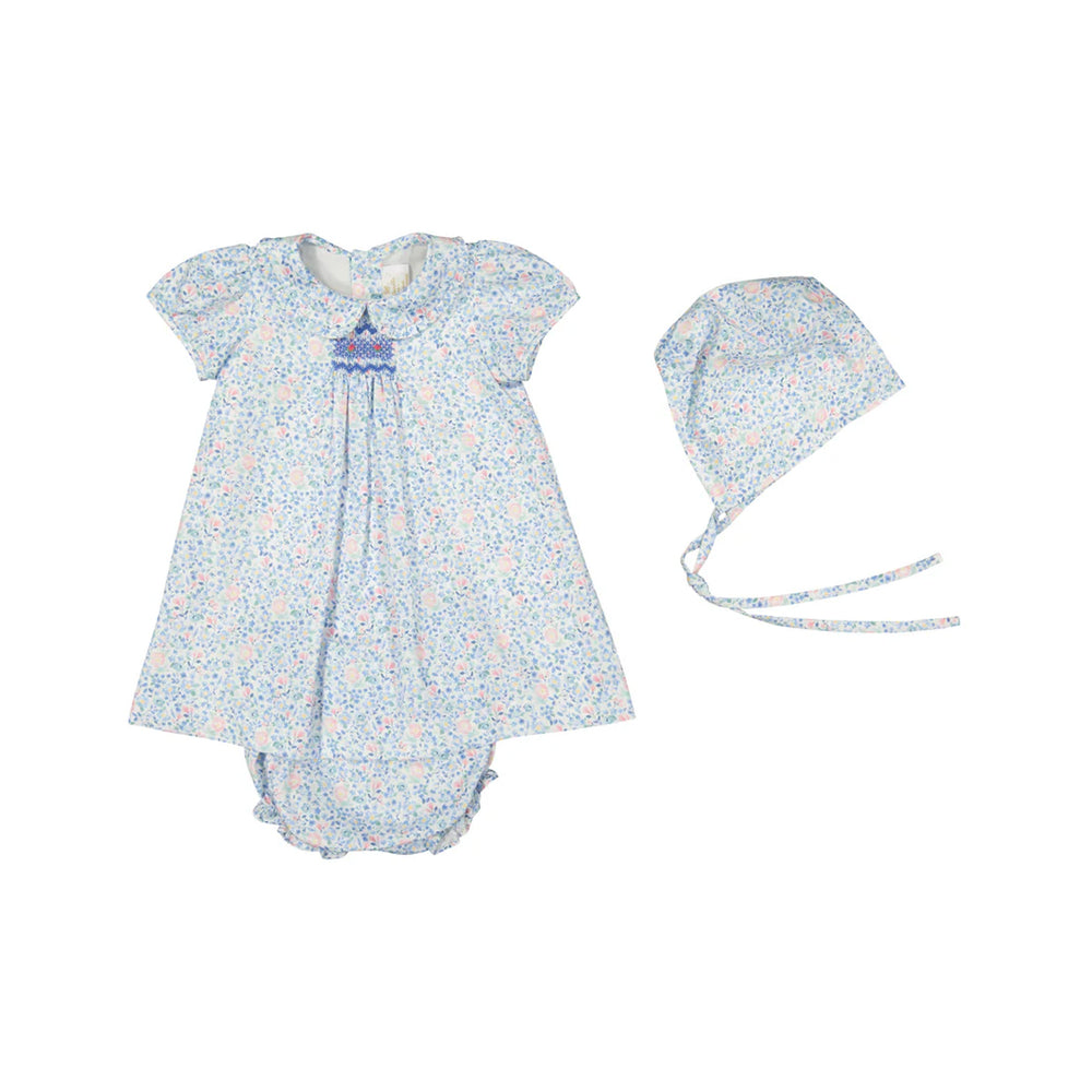 Front view of Olympe baby set with blue floral dress, smocked collar, matching bonnet and ruffled bloomer on white background