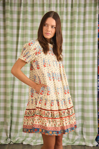 The Drifter Mini has a collared neckline, short puff sleeves, a drop waist and flounce hem.