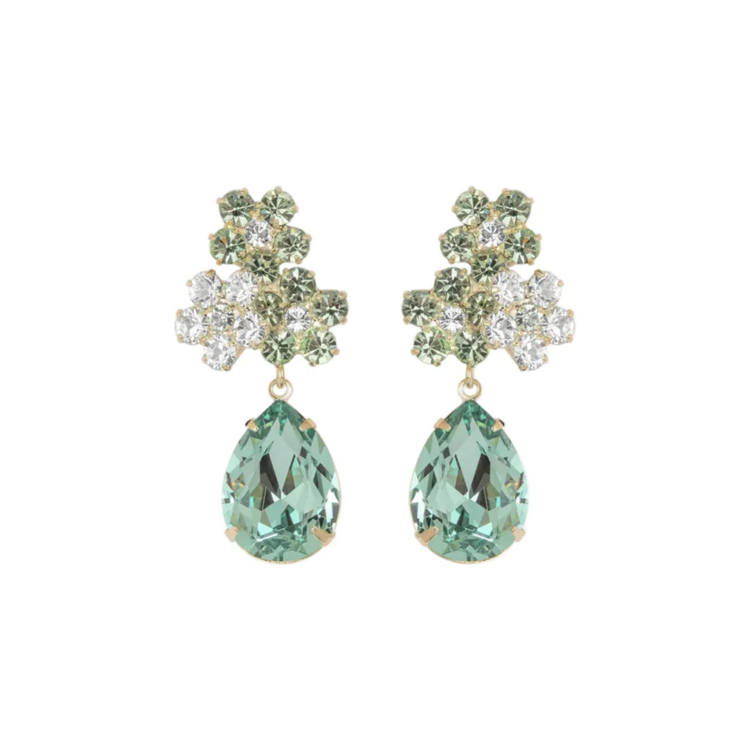 Front view of Lauretta earrings with pear-shaped chrysolite drops and floral crystal cluster on white background