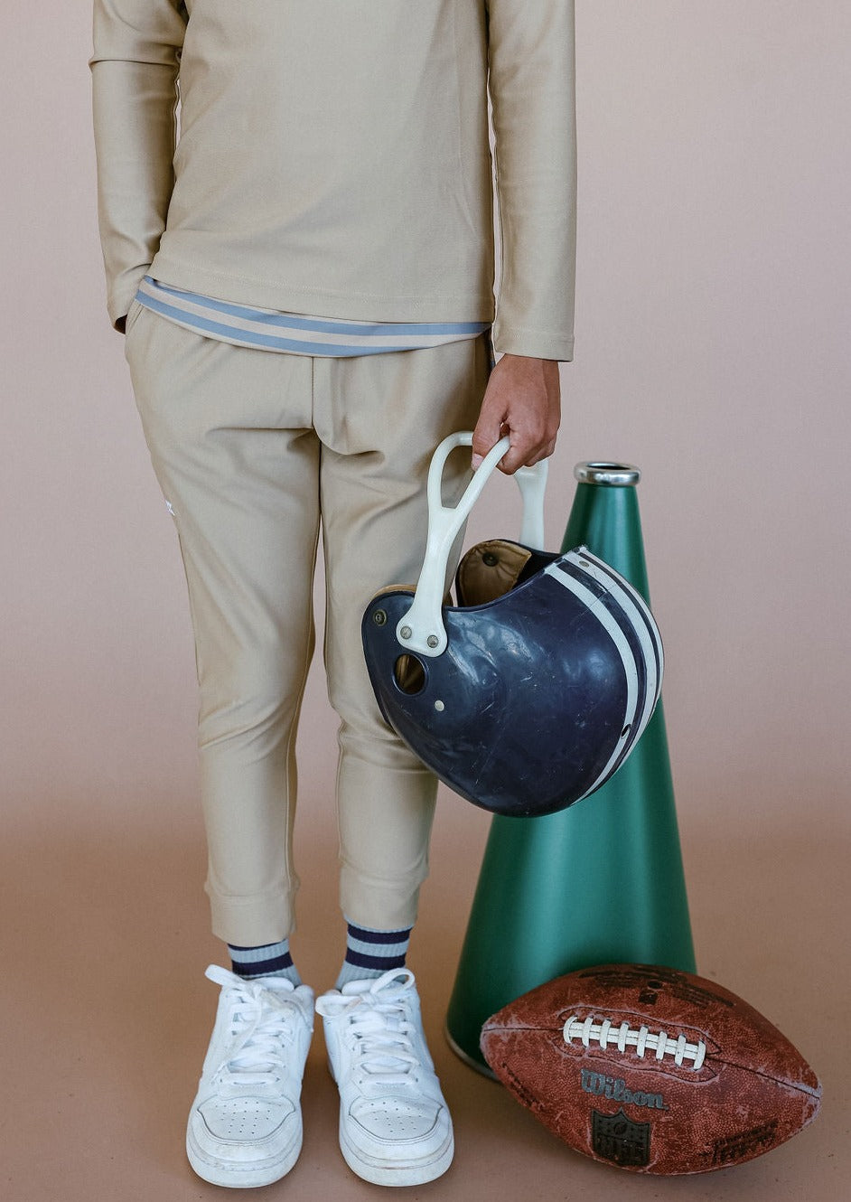 Front view of Warm-Up Joggers in khaki on child model showing slim fit hitting above the ankle with white sneakers