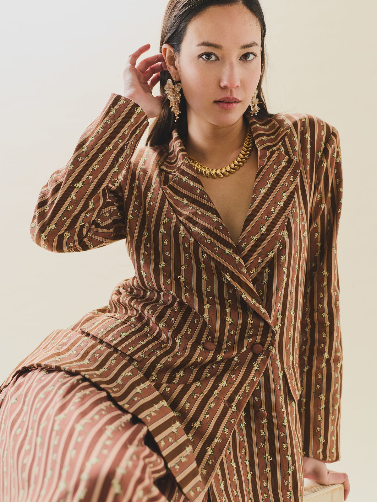 Three-quarter front of Sloan Blazer in Fresh Garden Floral on model showing double-breasted boxy fit with chocolate stripes and small floral print