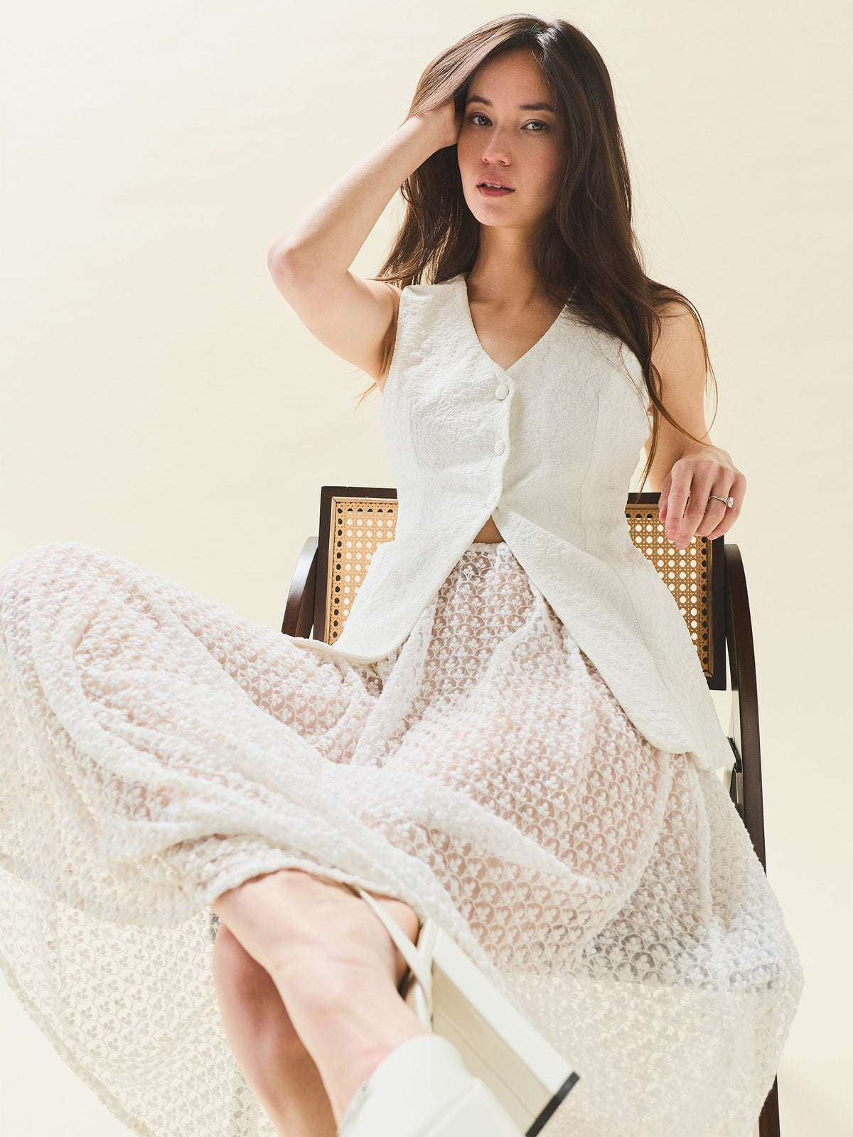 Seated front view of Erin Skirt in Amour White Embroidery with sheer floral overlay on neutral background
