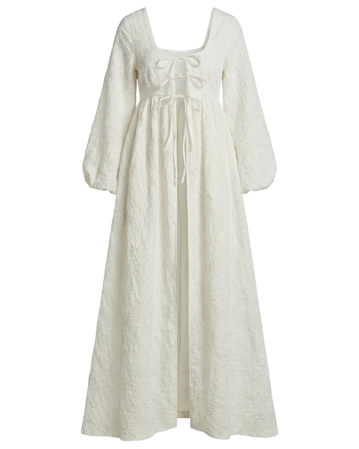 Front view of Sweet Pea Cape in Chapel White Floral with square neckline and ties, voluminous long sleeves, quilted floral fabric