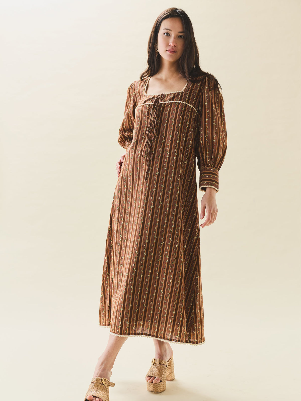 Front view of Tara Dress in Fresh Garden Floral showcasing square neckline, puff sleeves, front tie and cream ric-rac trim