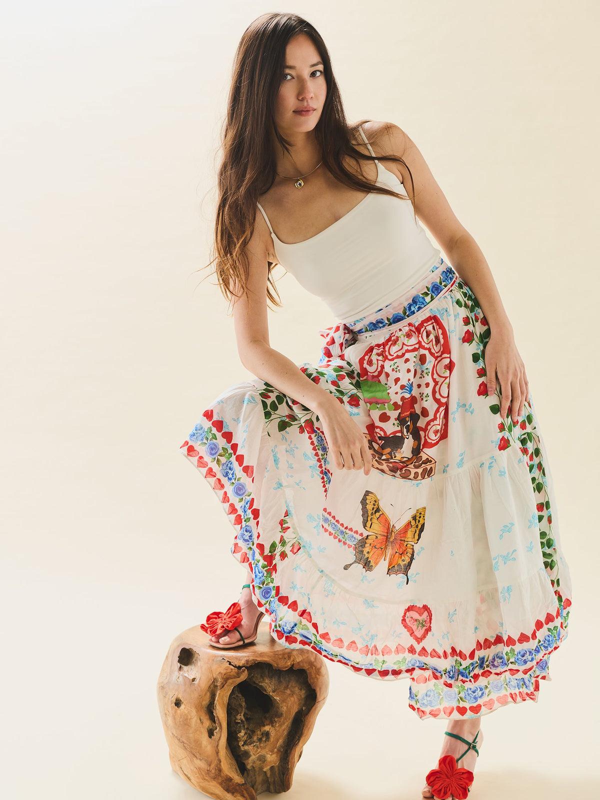 Full-length of Alfie Wrap Skirt in Alfie White on model showing conversation print with florals, butterflies, and wrap tie