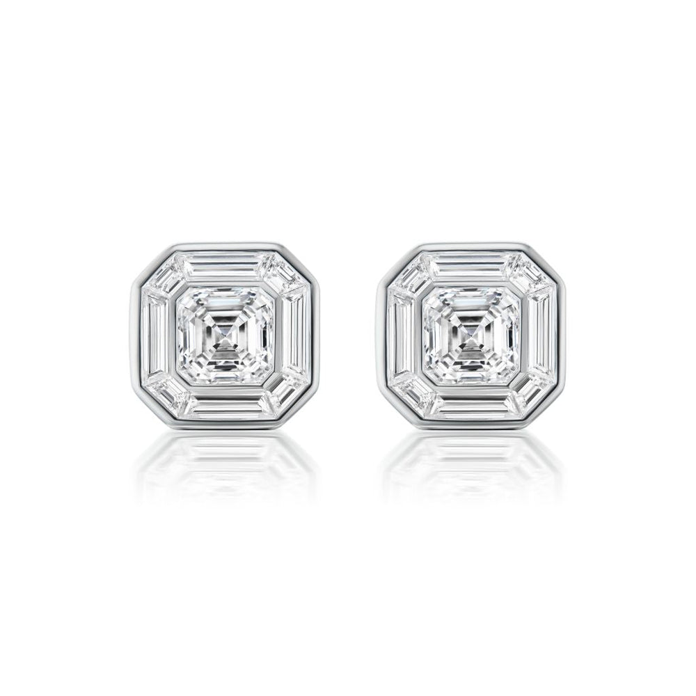 The Mosaic Studs feature central Asscher cut diamonds surrounded by baguette diamonds in a striking octagonal pattern, all set in 18k white gold.