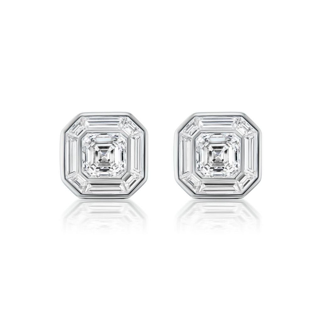 The Mosaic Studs feature central Asscher cut diamonds surrounded by baguette diamonds in a striking octagonal pattern, all set in 18k white gold.