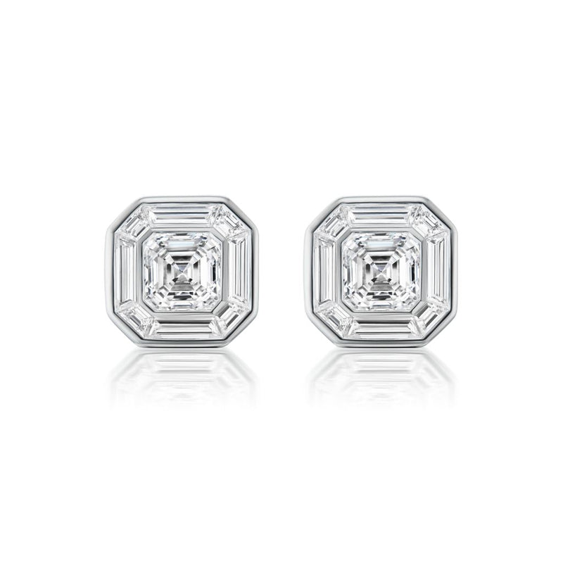 The Mosaic Studs feature central Asscher cut diamonds surrounded by baguette diamonds in a striking octagonal pattern, all set in 18k white gold.