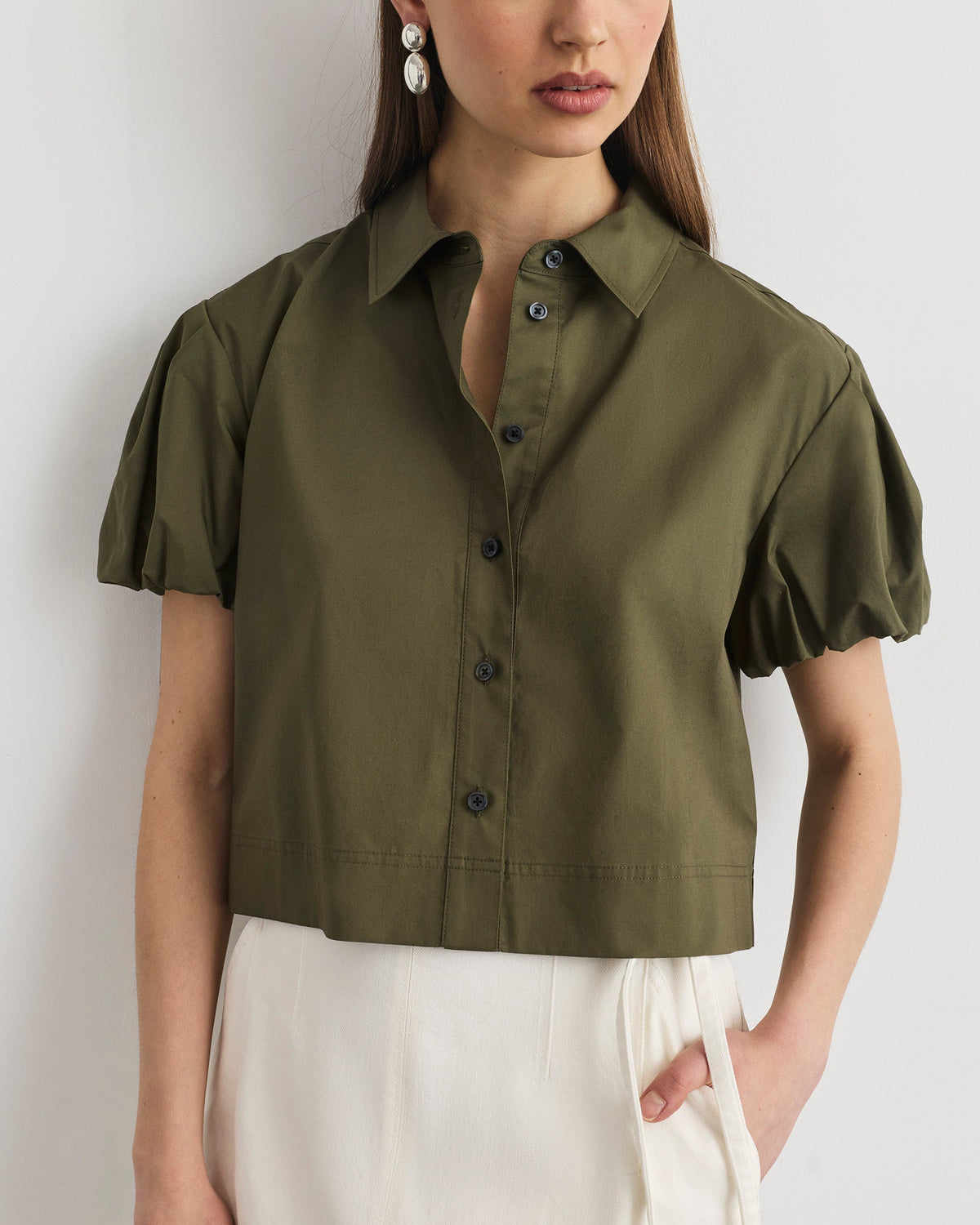Front view of Elza Top in fern showcasing short puff sleeves, button-front and straight cropped shape on white background