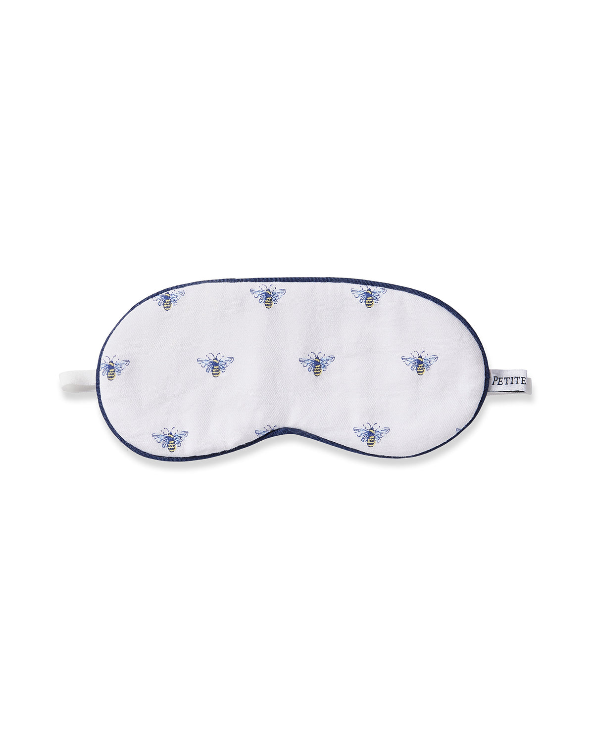 The Petite Plume Kids Twill Sleep Mask in Buzzing Bees is a white mask with blue and yellow bees pattern, dark blue trim, an elastic strap for comfort, and offers monogramming for personalization.