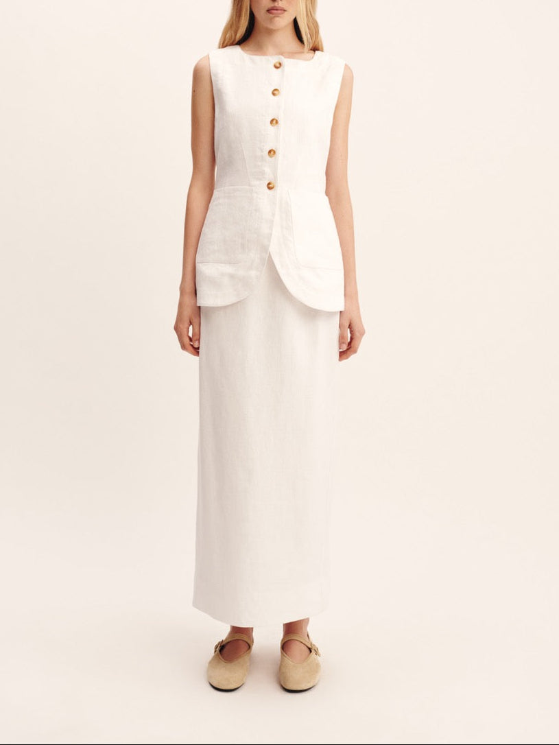 Front view of Emma Vest in Ivory on model, sleeveless tailored linen with high neckline, front buttons and scooped hem, plain background