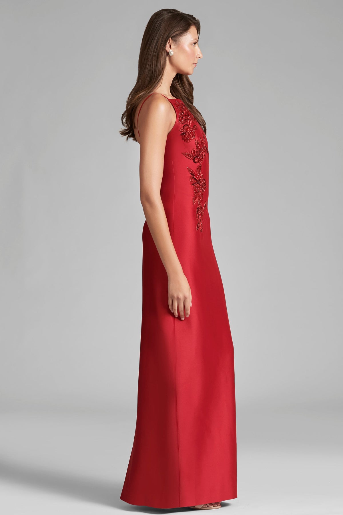 Side view of Embellished Pryce Gown in Holly Red showcasing crystal embellishment against a gray studio background