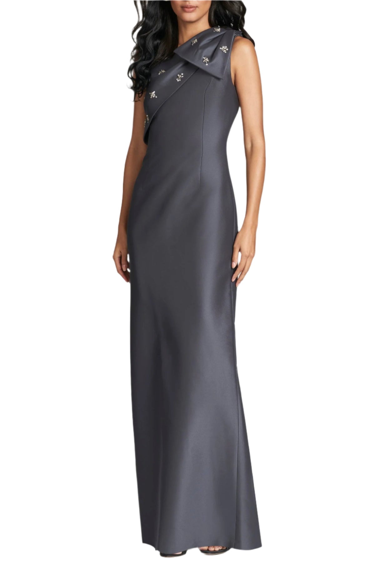 Front view of Olivia Gown in Charcoal showcasing one-shoulder styling, half bow, and neckline embellishment on white