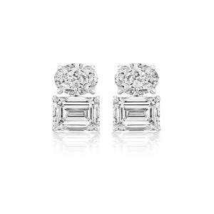A pair of East-West Set Oval and Emerald Cut Diamond Studs in white gold is displayed against a white background.