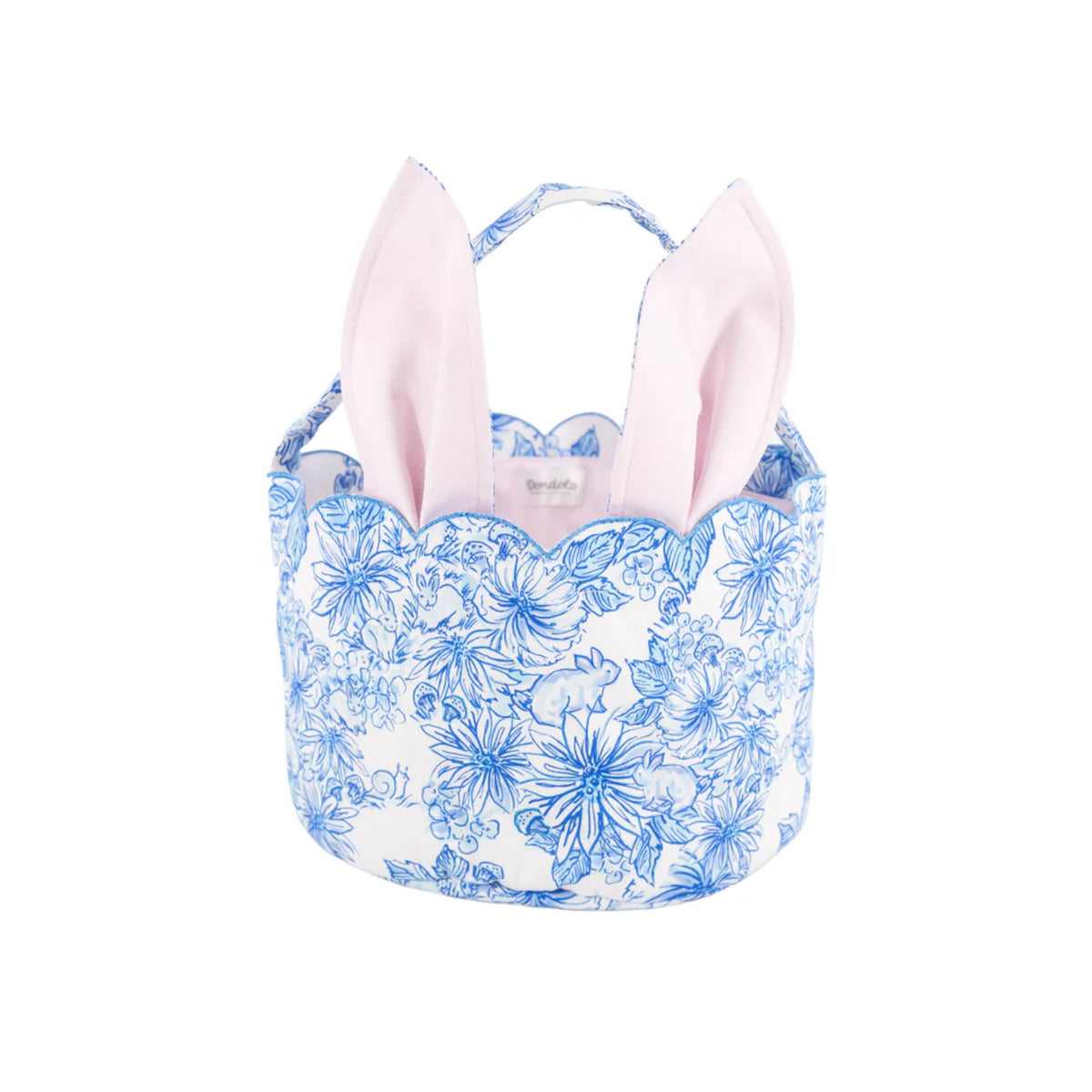 Front view of Easter Basket in Spring Meadow showcasing blue floral print, bunny motifs, and propped pink bunny ears against a white background
