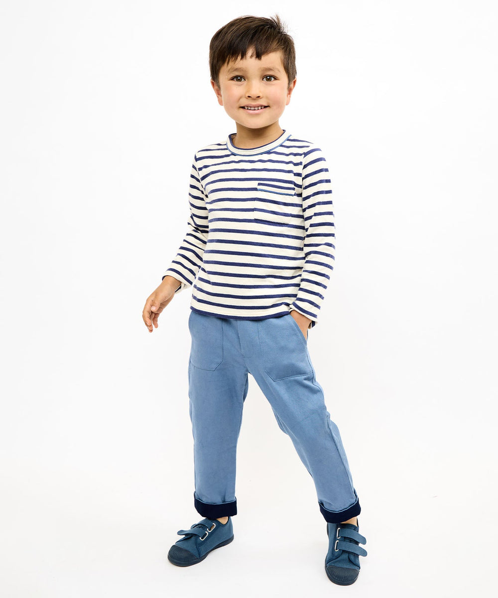 Front view of Edward long-sleeve T-shirt in navy stripe on child model showing chest pocket and contrast piping on white background