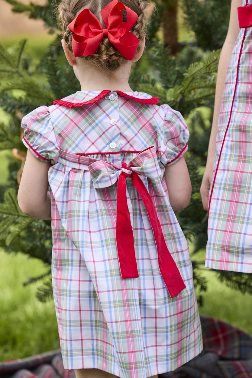 Little English classic children's clothing. Toddler girls puff sleeve dress in red and green plaid with ruffled peter pan collar and bow tie sash in back.