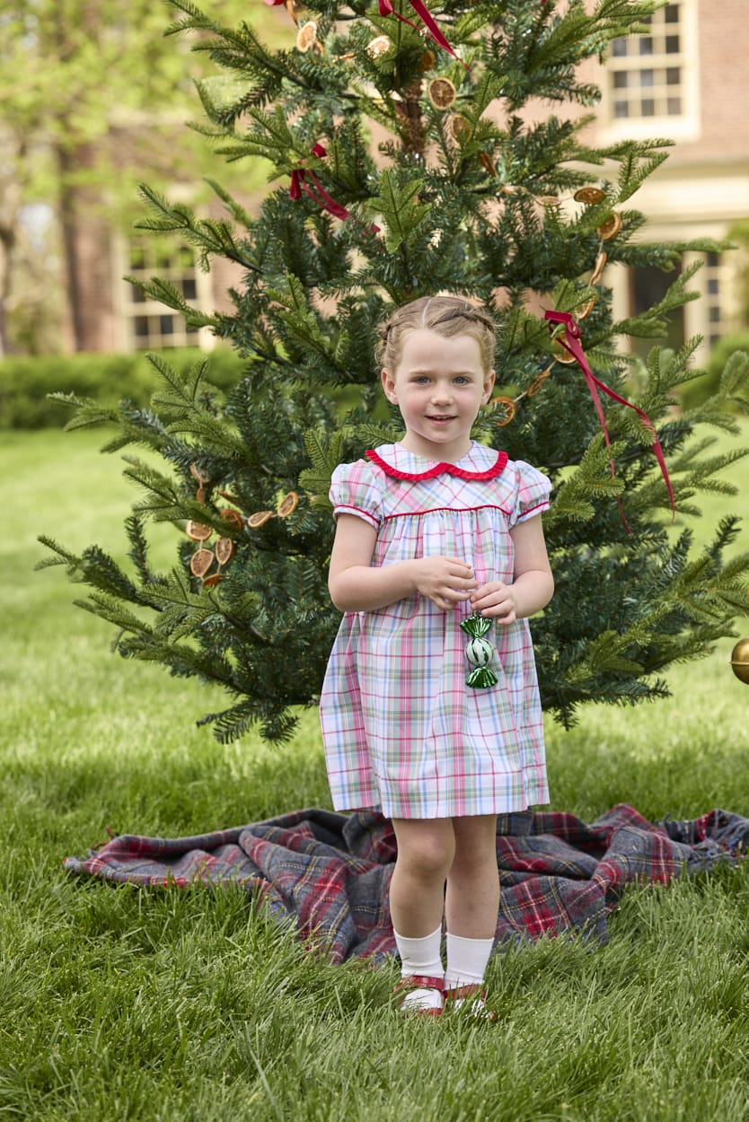 Little English classic children's clothing. Toddler girls puff sleeve dress in red and green plaid with ruffled peter pan collar and bow tie sash in back.