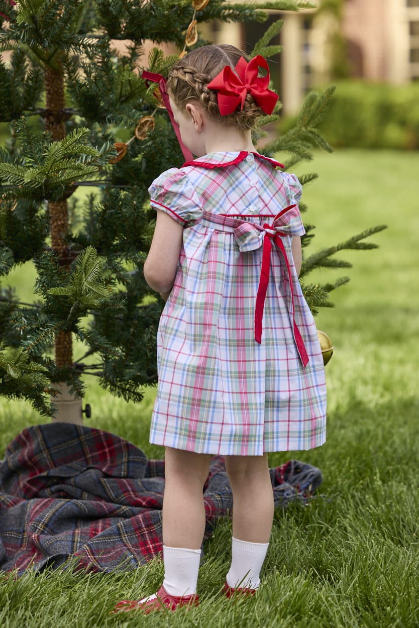 Little English classic children's clothing. Toddler girls puff sleeve dress in red and green plaid with ruffled peter pan collar and bow tie sash in back.
