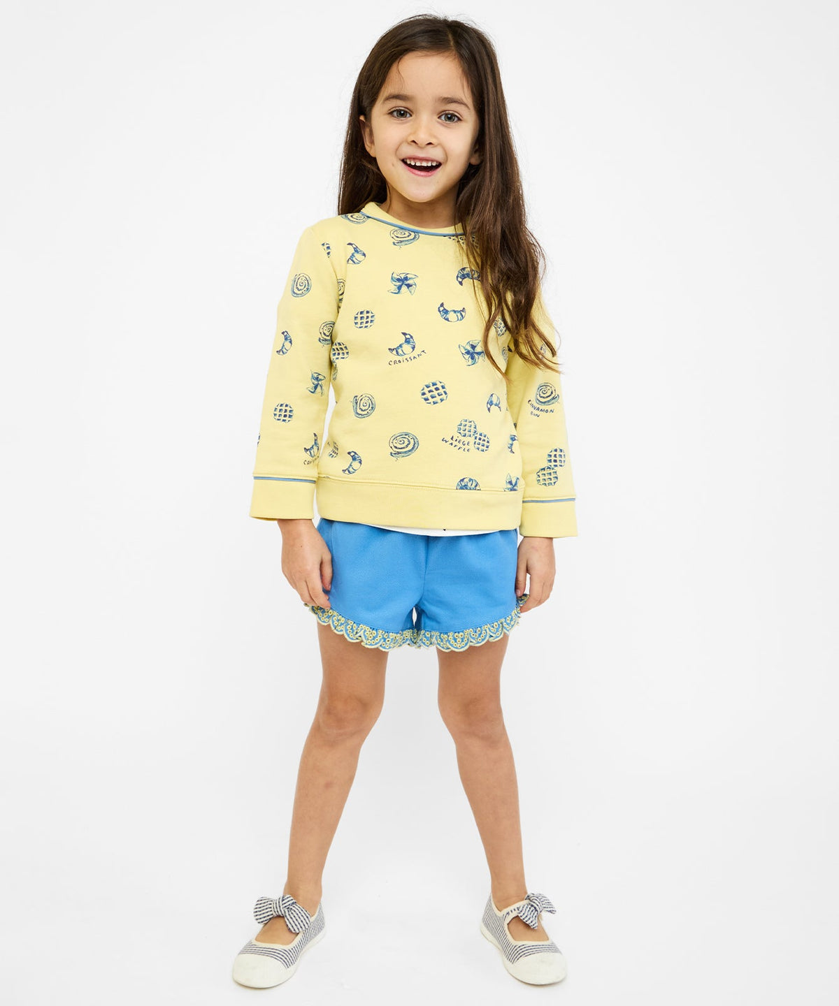 Front view of Eleanor Short in French Blue on child model showing scalloped trim and adjustable elastic drawstring waistband on white background