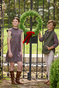 Little English traditional children's clothing. Olive and maroon Thornhill Plaid column dress with capped sleeves, ruffled neckline, and fixed bow in back for older girls for the holidays.  Boys Button Down Shirt in Thornhill Plaid with Classic Quilted Vest in Olive layered over top. Paired with Classic Pant in tan Stone Corduroy.