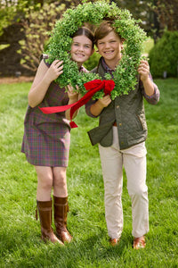Little English traditional children's clothing. Olive and maroon Thornhill Plaid column dress with capped sleeves, ruffled neckline, and fixed bow in back for older girls for the holidays.  Boys Button Down Shirt in Thornhill Plaid with Classic Quilted Vest in Olive layered over top. Paired with Classic Pant in tan Stone Corduroy.